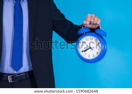 businessman with alarm clock in his hand