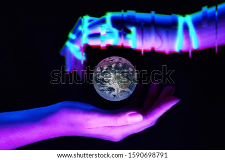 Earth between woman and robot's hands as symbol of partnership between people and technology for savety nature. Elements of this image are furnished by NASA