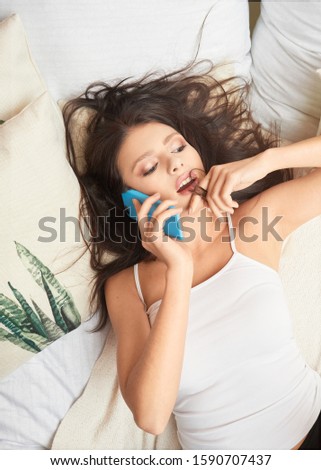 girl talking on the phone on the bed, boho style bedroom, natural and delicate brunette
