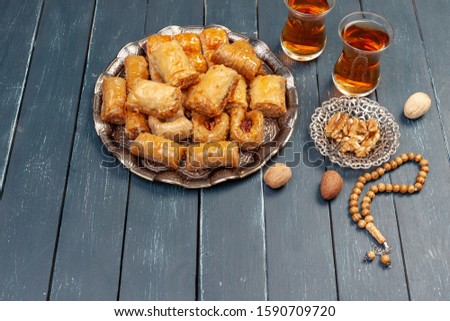 Top view of big metal tray with turkish baklava on planked wooden table