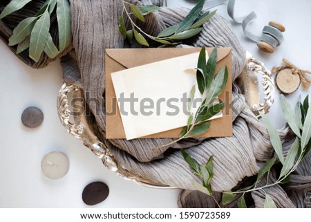 wedding invitation card with leaves and details. card mockup with envelope. stones, branch, fabric, ribbon, minimalism.