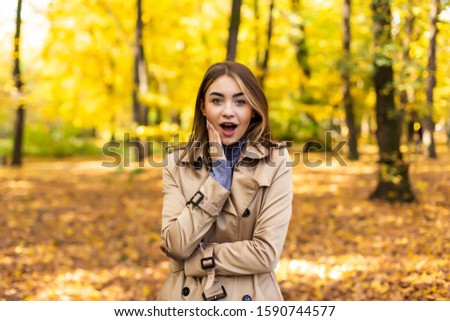 Portrait of an autumn woman with yellow leaves