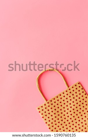 Shopping concept. Paper bag on pink background top-down copy space