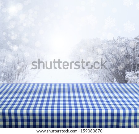Empty blue table with winter background. Ready for product display montage.