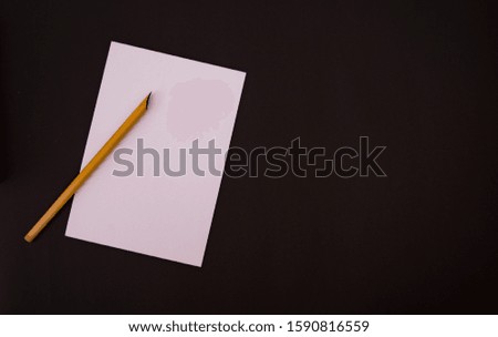 White Paper On a Black Background with calligraphy tools