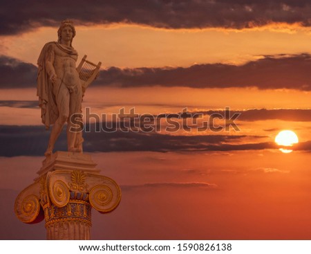 Apollo statue the ancient Greek god of poetry and music under dramatic magic hour sky, Athens Greece