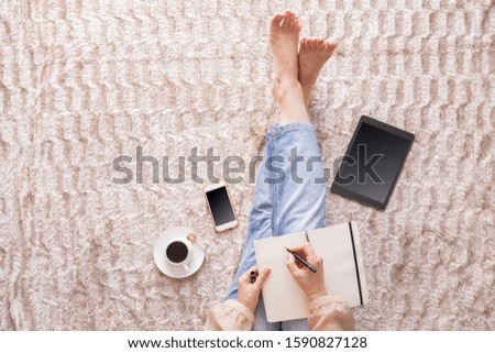 Woman writing a blog concept. Notebook and pen, woman accessories, clothing, shoes, bag, makeup and perfume. Fashion and Beauty flat lay.