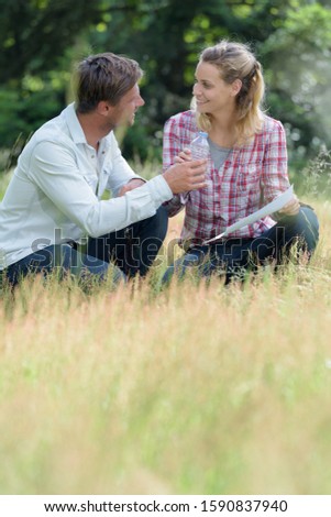 portrait of couple sitting on grass