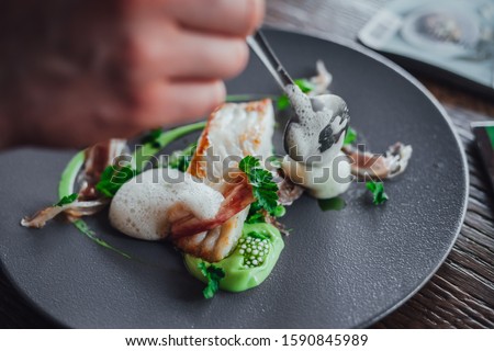 Fish food on plate  in michelin star restaurant  Royalty-Free Stock Photo #1590845989