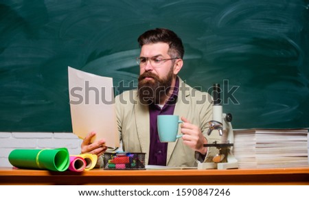 Reading essay. Handsome teacher relaxing. Teacher bearded man drinking tea chalkboard background. Self care and life balance. Coffee caffeine. Relax concept. College and high school teacher.