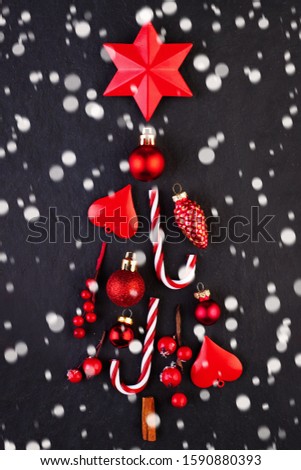 Red Christmas tree with snow on dark Xmas card background