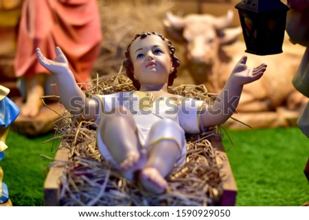 Statuettes of Mary, Joseph and baby Jesus,The birthday of Jesus is a statuette of Maria with Joseph and newborn Jesus on the hay, A Christmas nativity scene.
