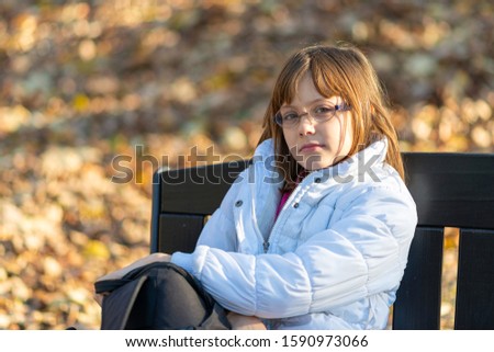 Girl sitting on banch in the park
