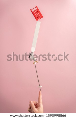 Creative winter holidays concept on pastel pink background in candy minimal style. Balancing and levitation. Trendy Christmas or New Year greeting card.