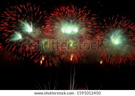 Colorful fireworks that explode and fill the darkness of the night sky with colored light.