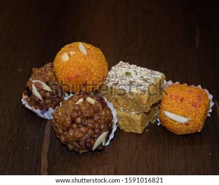 this is a pic of ladoos. it is popular in gujrat. it is known as ganpati prasad also. it is called as motichur ladoo . in this pic different flavour of ladoo