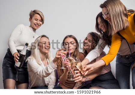 Beautiful girls having party fun, drinking champagne. Group photo of six happy fun women on hen party. Holidays, celebration and people concept
