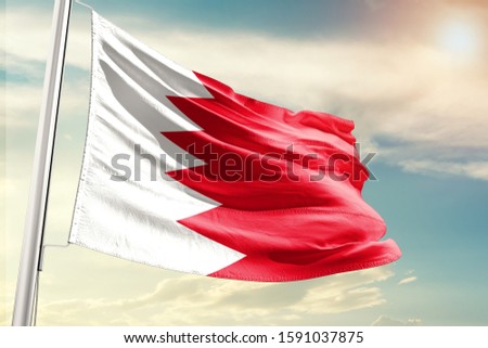 Bahrain national flag cloth fabric waving on the sky with beautiful sun light