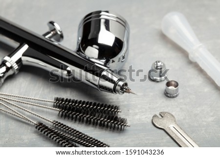 Airbrush cleaning. Brushes and other airbrush cleaning tools. Royalty-Free Stock Photo #1591043236