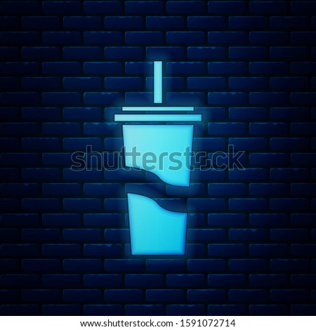 Glowing neon Paper glass with drinking straw and water icon isolated on brick wall background. Soda drink glass. Fresh cold beverage symbol.  
