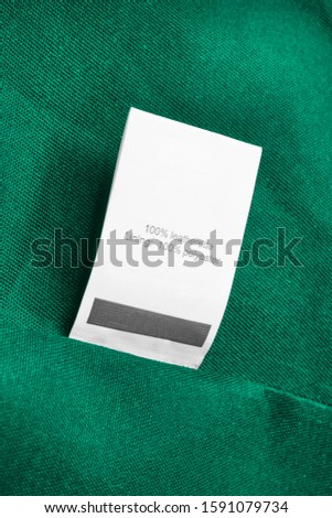 Composition clothes label on green textile background