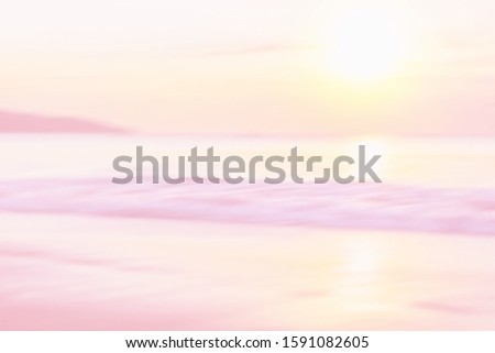 Relaxing view at blurred sunset on the sea.  Waves in soft focus. Tinted in pink shades.  Travel adventure concept.