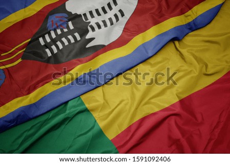 waving colorful flag of benin and national flag of swaziland. macro