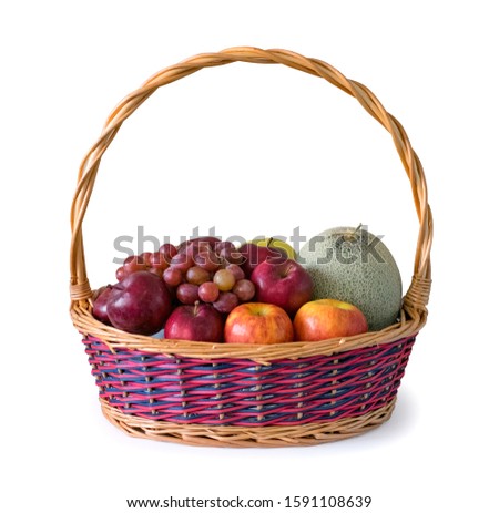 Mix of fruits in a wicker basket. A gift basket decorated isolated on white background. Clipping path image