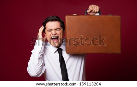 Man with case at red background