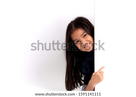 The Asian girl standing on the white background.