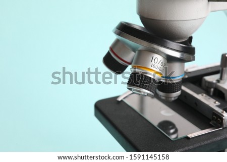 Chemistry microscope on modern blue background. Pharmaceutical industry concept