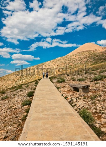 Panoramic view of the stairs and walking path leading to the top of Mount Nemrut. Archaeological site famous for its giant stone statues. Nemrut Dagi. Turkey