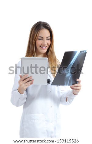 Female doctor comparing a tablet image with a radiography isolated on a white background