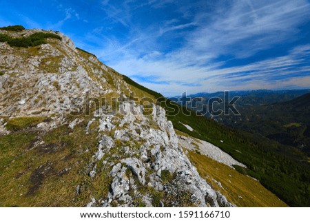 Sharp Alps peaks, rocks without people. View over Alpine rocks above deep vallyes to far horizon