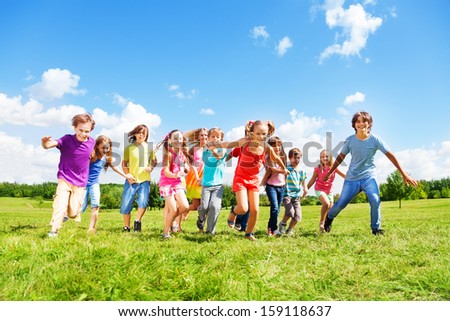 Large group of kids, friends boys and girls running in the park on sunny summer day in casual clothes Royalty-Free Stock Photo #159118637