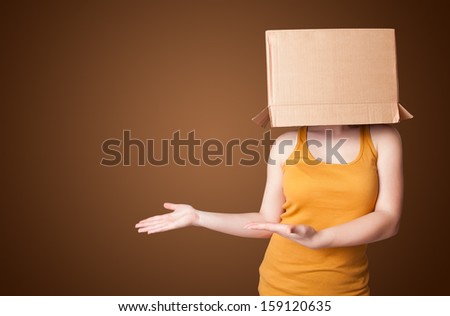 Young girl standing and gesturing with a cardboard box on his head