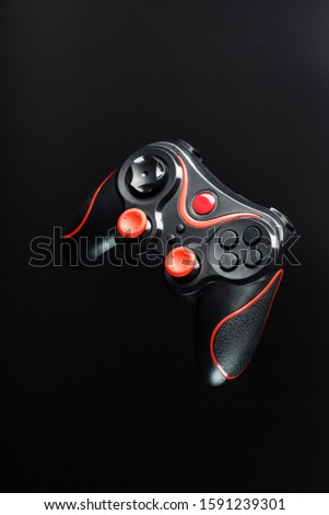 Game controller gamepad on black background. Device to control and control the game.