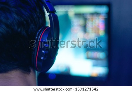 Man in headphones plays a computer game