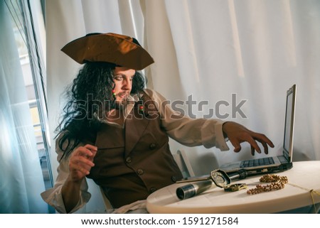 a computer pirate sitting at the laptop funny concept of digital security   