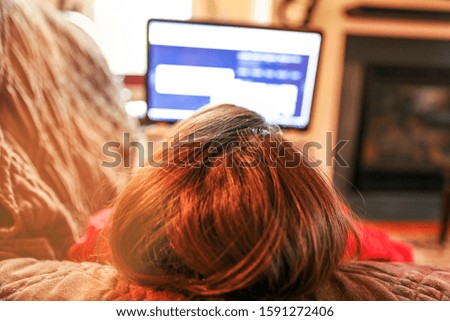 Blonde Young Woman Using PC on Sofa stock photo