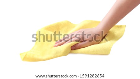 Hand with cleaning yellow micro fiber cloth isolated on white.Household. Royalty-Free Stock Photo #1591282654