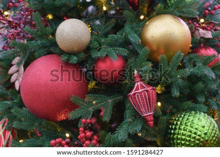 Bright red color New Year decoration of fir. Christmas Eve festive mood and atmosphere. High resolution photography. Suitable for greeting cards, postcards, posters. 