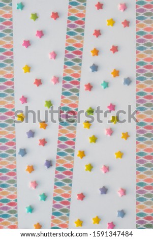 Colorful bands and star sprinkles of sugar on white background. Expresses a happy feeling.
