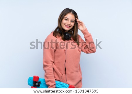 Young skater girl over isolated background
