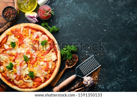Homemade pizza with chicken, tomatoes and corn. Top view. free space for your text. Rustic style.