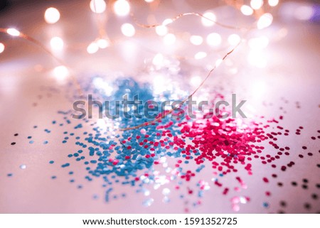 Splash of blue and pink sparkles on black background. Blue color of the year 2020 concept.
