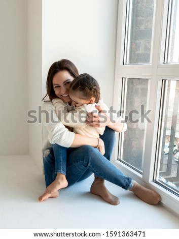 Happy loving family. mother and child girl playing, kissing and hugging.