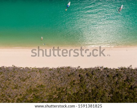 Whitsundays beach aerial view, with turquoise ocean, white sand. Dramatic DRONE view from above. Travel, holiday, vacation, paradise concepts. Shot in Whitsundays Islands, Queenstown, Australia.