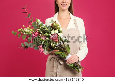 Florist with beautiful bouquet on pink background, closeup