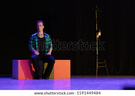 Actor dancer young man performs in the theater on stage in a dance musical show